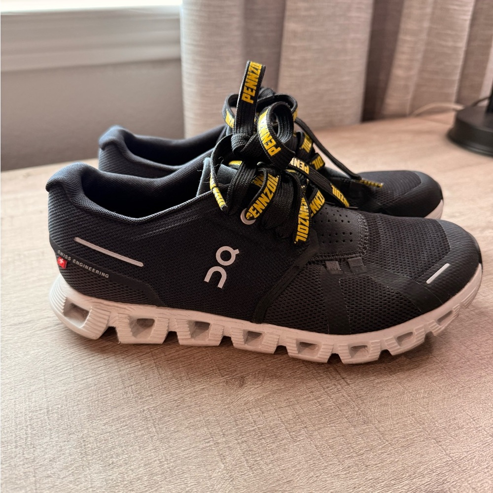 On Running Black Shoes with White and Yellow Accents